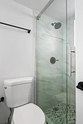a bathroom with a toilet and a glass shower at Palms 811 in Miami Beach