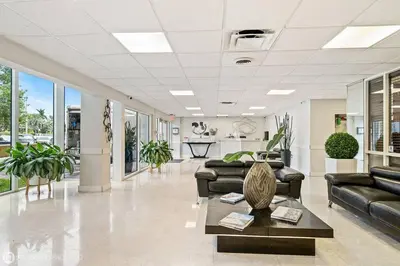 a lobby with couches and a table in a building at Palms 811 in Miami Beach