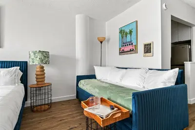a small room with a bed and a table at Palms 811 in Miami Beach