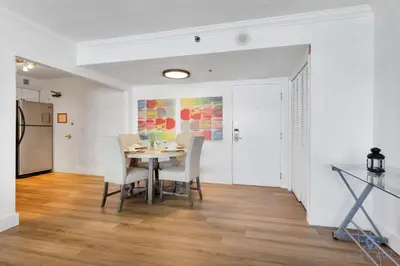a dining room with a table and chairs at 2BR Pool Ocean View in Miami Beach