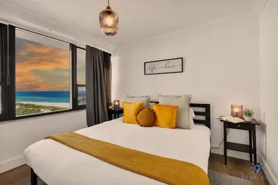 a bedroom with a bed and a large window at 2BR Pool Ocean View in Miami Beach