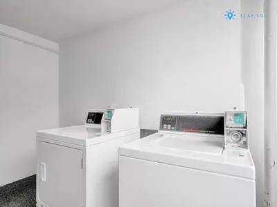 a white laundry room with a washer and dryer at 2BR Pool Ocean View in Miami Beach