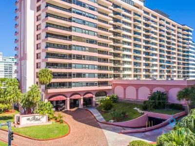 a large apartment building with a park in front of it at 2BR Pool Ocean View in Miami Beach