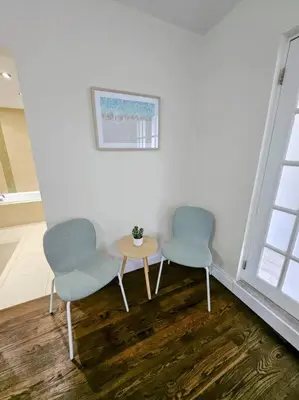 two chairs and a table in a room at Brickell Enclave Sunny Retreat with pool in Miami