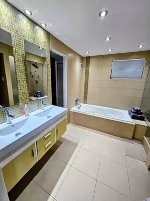 a large bathroom with two sinks and a tub at Brickell Enclave Sunny Retreat with pool in Miami