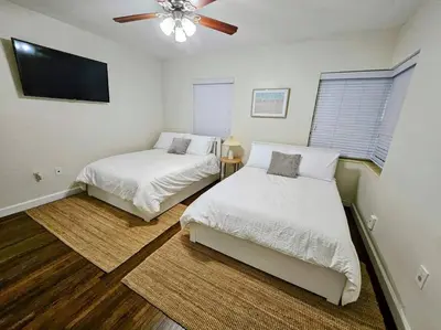 a bedroom with two beds and a ceiling fan at Brickell Enclave Sunny Retreat with pool in Miami