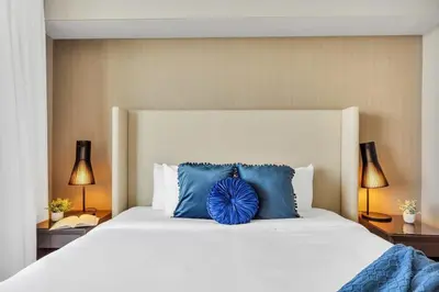 a bedroom with a large bed with blue pillows at 1BR Apartment - Near Beach - Amazing pool in Hollywood
