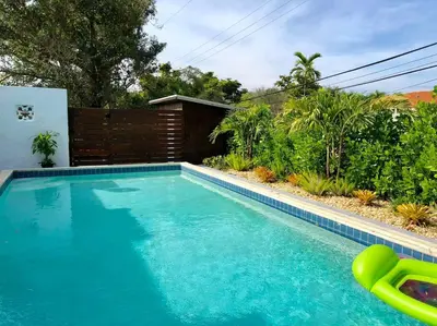 a swimming pool in front of a house at HOUSE WITH POOL and BBQ, 12 MIN to the BEACH in Miami Shores