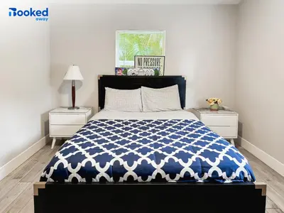 a bedroom with a blue and white bed and two night stands at HOUSE WITH POOL and BBQ, 12 MIN to the BEACH in Miami Shores