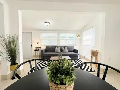 a living room with a table and a couch at Modern Miami Family Cottage Beach 15 min in Miami