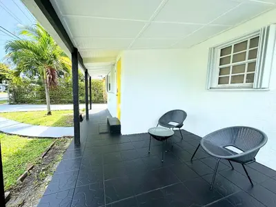 a patio with two chairs and a table at Modern Miami Family Cottage Beach 15 min in Miami