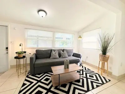 a living room with a couch and a coffee table at Modern Miami Family Cottage Beach 15 min in Miami