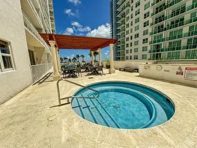 a swimming pool on a balcony of a building at Elegant Centric Vibrant Pool Jacuzzi Free Parking in Miami