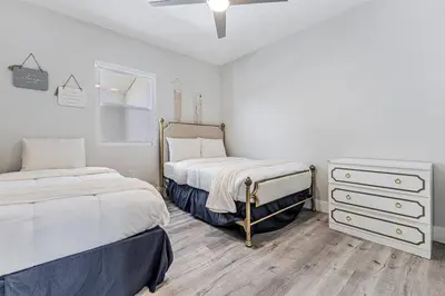 a bedroom with two beds and a dresser in it at Modern Miami Unit 1 - Close to South Beach & Airport in Miami