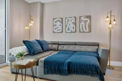 a living room with a couch with a blue blanket at Beautiful 1BR Apartment with Amenities in Miami