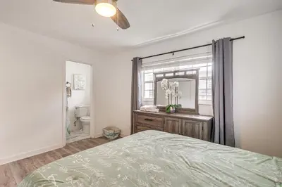 a bedroom with a bed and a mirror at Hollywood Hideaway Close to Dtwn and Beaches in Hollywood