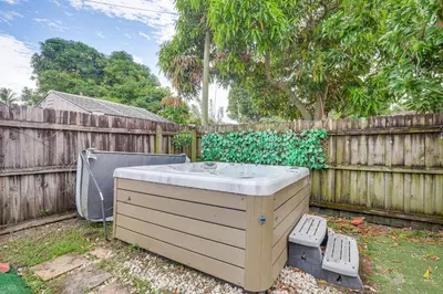 a hot tub in a yard next to a fence at Hollywood Hideaway Close to Dtwn and Beaches in Hollywood