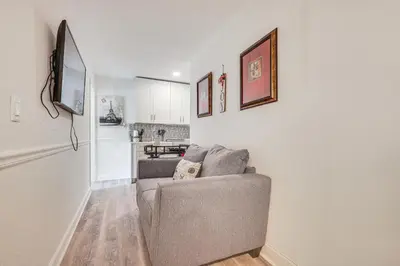 a living room with a couch and a kitchen at Hollywood Hideaway Close to Dtwn and Beaches in Hollywood