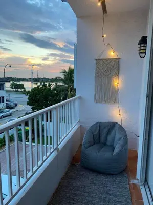 a blue bean bag chair sitting on a balcony at Hollywood Townhouse steps to beach and famous Broadwalk in Hollywood Beach