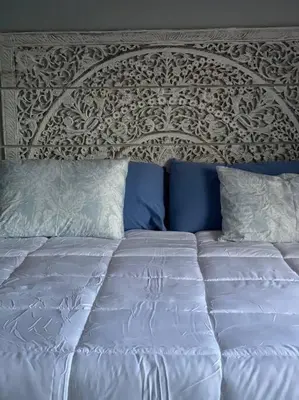 a bed with white sheets and blue pillows at Hollywood Townhouse steps to beach and famous Broadwalk in Hollywood Beach