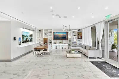 a living room with a couch and a table at Grand Deluxe Two Bedroom Suite with Balcony Water Views, Corner in Miami Beach
