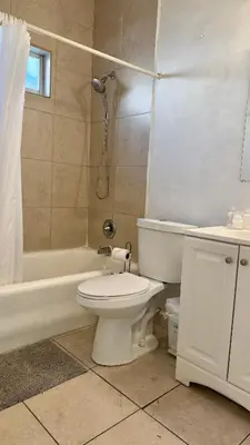a bathroom with a toilet and a tub and a sink at Private Rooms at Miami, Buena Vista with Parking in Miami