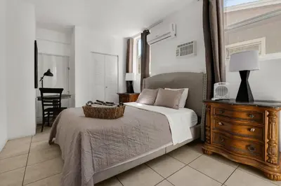 a bedroom with a bed and a dresser and a desk at Private Rooms at Miami, Buena Vista with Parking in Miami