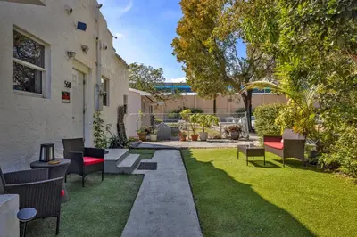 a patio with chairs and a grass yard at Private Rooms at Miami, Buena Vista with Parking in Miami