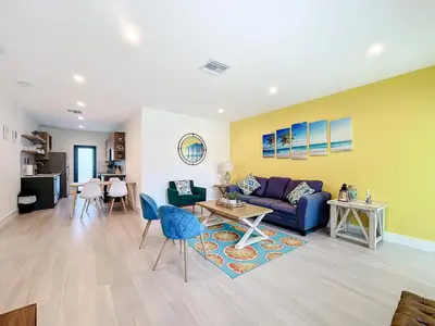 a living room with a couch and a table at Los Patios Home Suites in Miami Beach