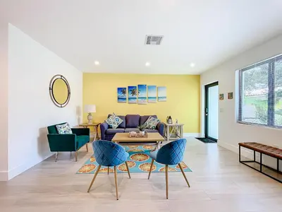 a living room with a couch and a table at Los Patios Home Suites in Miami Beach