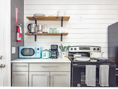 a kitchen with a stove and a microwave at Melrose Villa in Miami