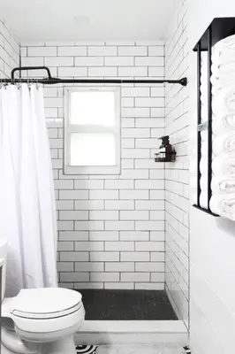 a white bathroom with a toilet and a window at Melrose Villa in Miami