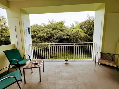 a balcony with a table and chairs on a porch at Doral Pool 310 by WaveProperties in Miami
