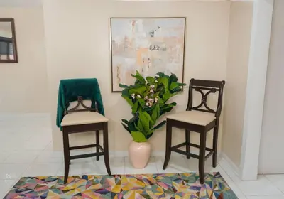 two chairs and a vase with flowers in a room at CasaBay 4 Bed 2 Bath House Ultimate Backyard Fun in Cutler Bay