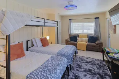 a bedroom with two beds and a couch at CasaBay 4 Bed 2 Bath House Ultimate Backyard Fun in Cutler Bay