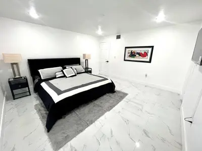 a black and white bedroom with a large bed at Miami Oasis Near Beach in North Miami