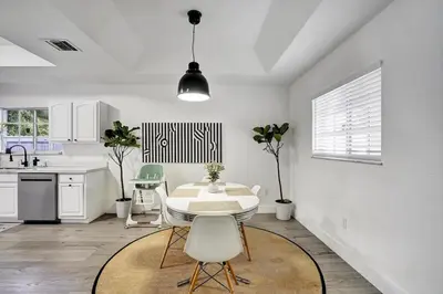 a kitchen with a table and chairs in a room at 8BR-4BA Spacious House, Sleeps 20, Pool, Fenced Yd in Miami