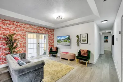 a living room with a couch and a chair at 8BR-4BA Spacious House, Sleeps 20, Pool, Fenced Yd in Miami