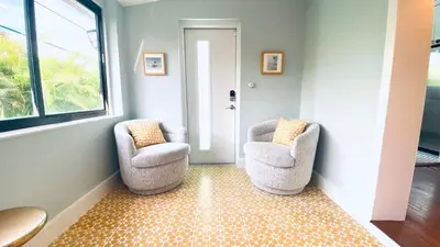two chairs sitting in a hallway next to a window at Experience Miami Magic: Tropical Pool Escape in Miami