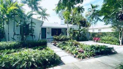 a house with palm trees and a garden at Experience Miami Magic: Tropical Pool Escape in Miami