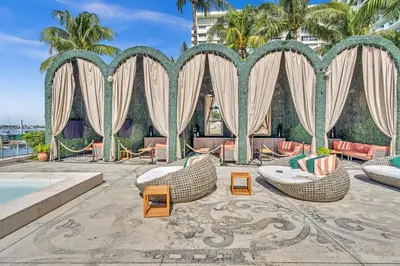 a resort with a pool and chairs and trees at 1100 West South Beach Lux Waterfront Studio in Miami Beach