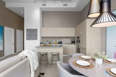 a kitchen and living room with a couch and a table at 1 BR Apartment with Bay View and Parking Included in Hollywood