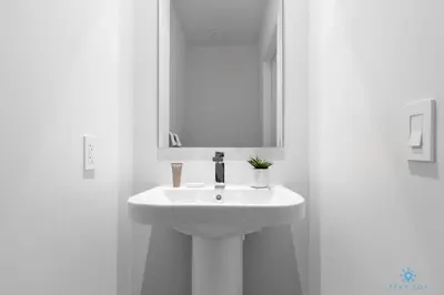 a bathroom with a white sink and a mirror at 1 BR Apartment with Bay View and Parking Included in Hollywood