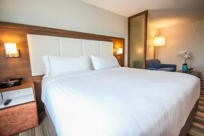 a large white bed in a hotel room at Holiday Inn Express & Suites Miami Airport East by IHG in Miami
