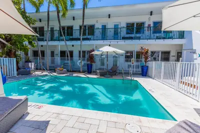 a swimming pool in front of a building at Seaside All Suites Hotel in Miami Beach