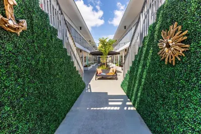 a building with a large green hedge in a hallway at Seaside All Suites Hotel in Miami Beach