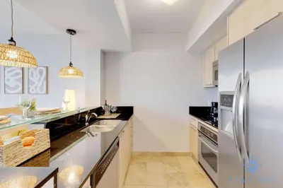 a kitchen with a sink and a refrigerator at 1BR Apartment with beautiful view in Sunny Isles Beach