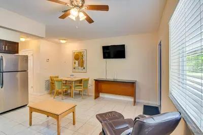 a living room with a ceiling fan and a table at Centrally Located Hallandale Beach Condo in Hallandale Beach
