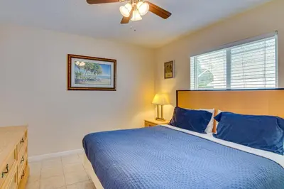 a bedroom with a blue bed and a window at Centrally Located Hallandale Beach Condo in Hallandale Beach