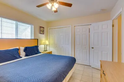 a bedroom with a blue bed and a ceiling fan at Centrally Located Hallandale Beach Condo in Hallandale Beach